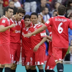 Sevilla's players celebrating the team's goal at Cornellà-El Prat Stadium